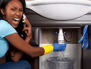 Emergency plumbing repair for a leaking sink drain under a bathroom vanity in Los Angeles, CA