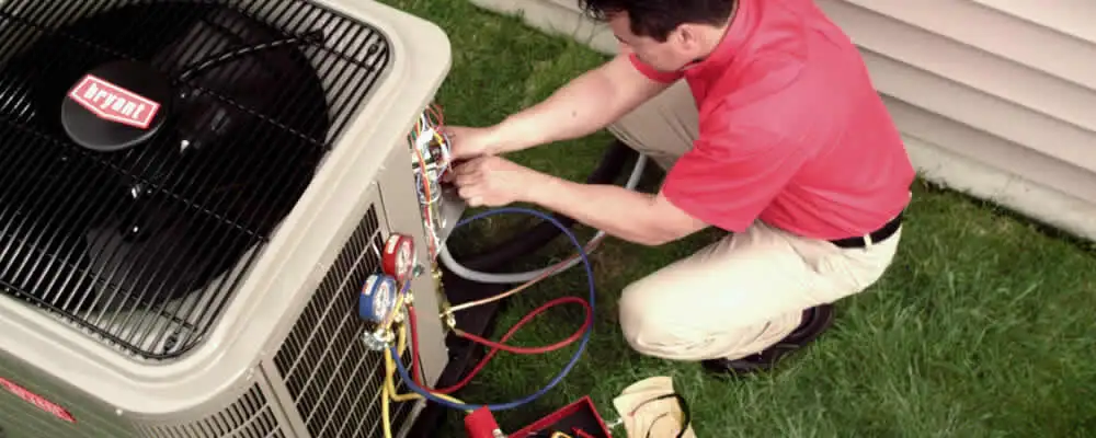 HVAC technician servicing an outdoor air conditioner unit in Los Angeles, CA