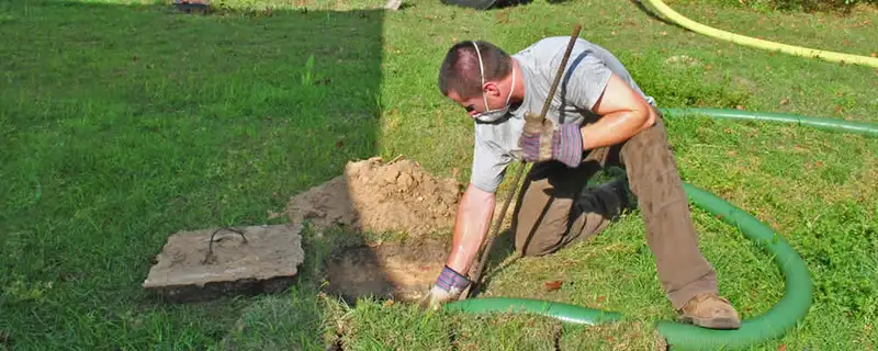 Septic pumping technician servicing a residential septic tank in Los Angeles, CA